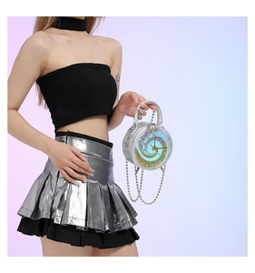 Detail of round hologram crossbody bag featuring a golden clock face and silver chain