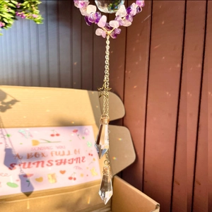 Close-up of Amethyst suncatcher with crystal prisms creating rainbow light in sunlight