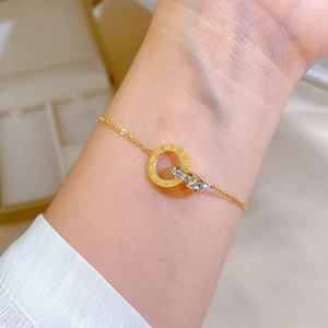 Elegant gold titanium steel bracelet featuring roman numeral rings and white zircon crystals
