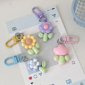 Macro detail of 3D macaron flower keychains in purple yellow blue and pink colors