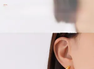 Close-up of elegant 18K gold plated stainless steel C-shaped hoop earring on a model