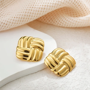 Minimalist 18k gold plated stainless steel textured hoop earrings on a display stand