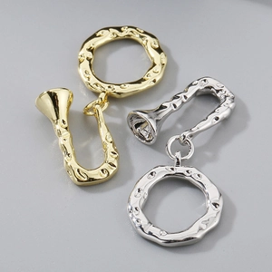 Detailed view of 18K gold and silver plated OT toggle clasps with baroque hammered textures