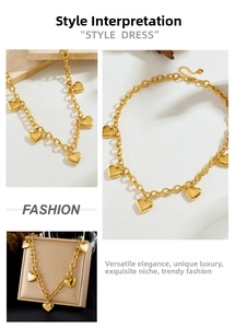 Close-up of gold plated heart charm necklace with thick round chain and five pendants