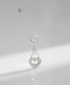 Macro detail of S925 sterling silver heart lock pendant with sparkling zircon micro-pave