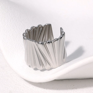 Detailed view of silver stainless steel open ring featuring wide radial pleat texture