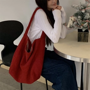 Red plaid plush tote bag for women shown in a cozy indoor winter setting