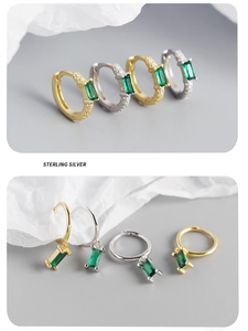 Detailed macro view of gold and silver S925 sterling silver emerald hoop earrings