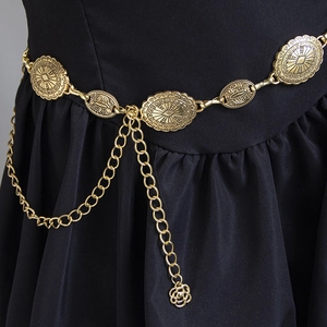 Close-up of bohemian gold concho waist chain with vintage embossed metal discs