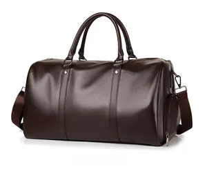 Detail view of deep brown pebbled leather travel bag with dual handles and adjustable strap