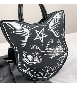 Detailed macro view of black punk gothic cat face handbag with pentagram print on PU leather
