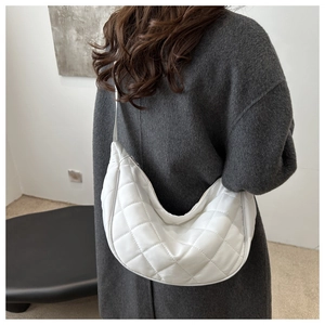 Détail du sac bandoulière blanc en forme de croissant avec surpiqûres en losanges chic