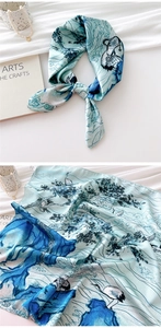 Detailed view of silk scarf with traditional crane and pine ink painting patterns