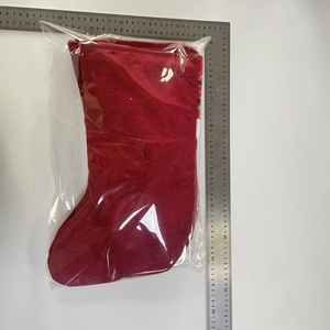 Detail of red plaid Christmas stocking in packaging with a ruler showing 45cm length