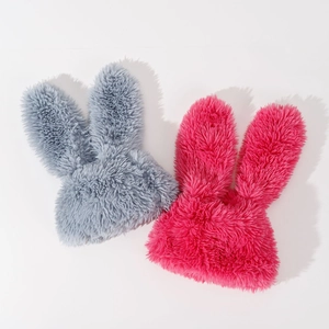Flat lay of pink and grey plush bunny ear hats showing soft faux fur texture and details