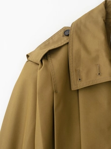 Detail of khaki twill jacket showing lapel collar, epaulettes, and button construction