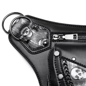 Detail of PU leather bag featuring silver skull print and metallic rivet decorations