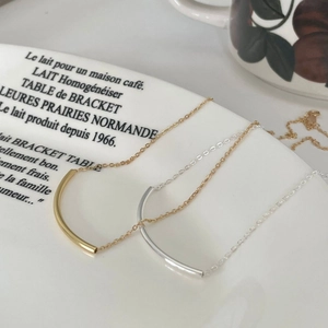 Detail of minimalist 925 silver square tube bar necklaces in gold and silver finishes