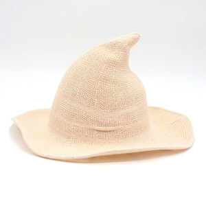 Beige knitted witch hat with long pointed top and wide wavy brim for Halloween