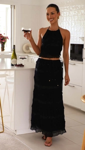 Detail of black two-piece chiffon set with tiered maxi skirt and halter neck top
