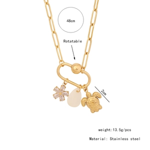 Detail of rotatable gold stainless steel chain with sea turtle and flower pendants