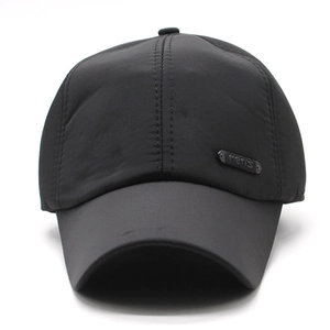 Detailed view of black baseball cap featuring a premium metal plate with men's engraving