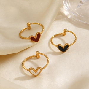 Golden heart-shaped adjustable rings with red, black and white enamel on silk background