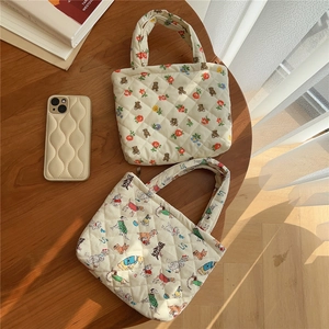 Detailed top view of quilted cotton mini bags and matching phone case with cute animal prints
