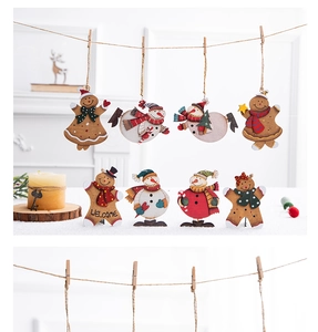 Close-up of vintage wooden gingerbread man ornaments with Welcome text on a white background