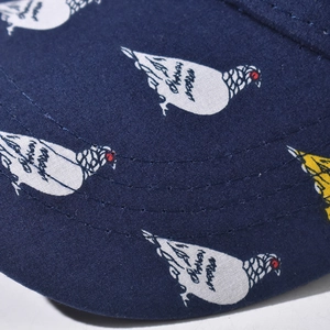 Detail of navy cotton twill brim featuring white pigeon prints and precision stitching