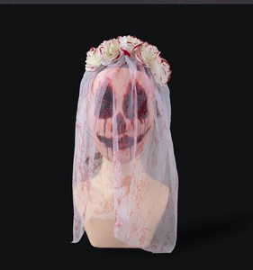 Macro detail of Halloween ghost bride veil with red blood splatters and white roses