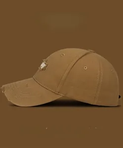 Detailed side view of brown vintage baseball cap with distressed brim and embroidery