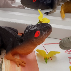 Macro shot of detailed grey and orange 3D resin dinosaur mold for DIY craft jewelry making