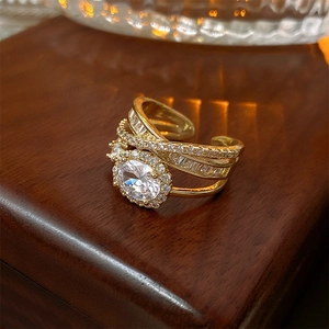 Macro shot of gold layered ring featuring a central oval stone and pavé setting detail