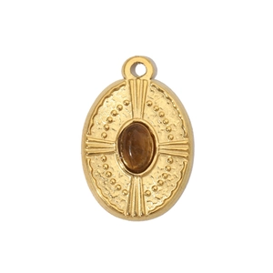 Detailed macro shot of vintage gold oval pendant with brown stone and radial textures