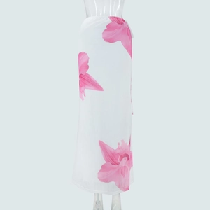 Detail of white mesh skirt featuring elegant pink lily print and side tie-up closure