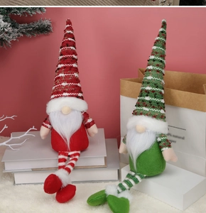 Close-up of Nordic knitted Christmas gnomes with long striped legs for home decor