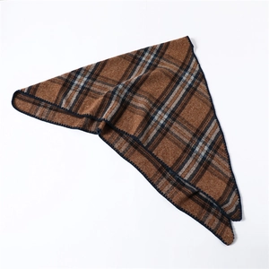 Detail of soft brown plaid scarf with reinforced navy blue edge stitching texture