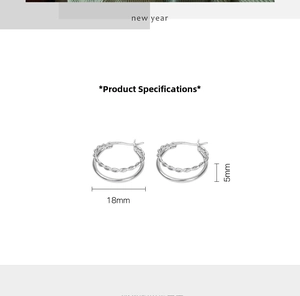 Detail view of double-layer silver hoop earrings with 18mm diameter and twisted texture