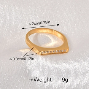 Polished gold titanium ring with horizontal rectangle bar pave set with small diamonds