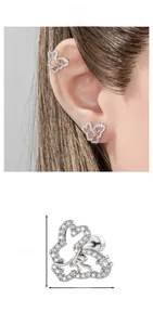 Macro detail of bow-shaped cartilage stud earring with cubic zirconia and size dimensions