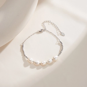 Macro shot of S925 sterling silver tag and natural freshwater pearls on the bracelet