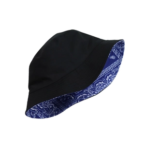Reversible black and blue paisley bucket hat featuring a wide brim and cotton fabric