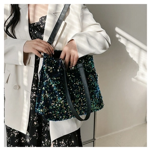 Close-up of green and blue sequins tote bag with durable black leather shoulder straps