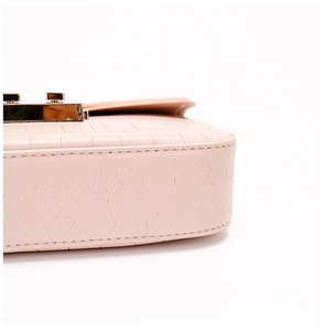 Detailed close-up of pink croc-embossed leather handbag with a gold square clasp