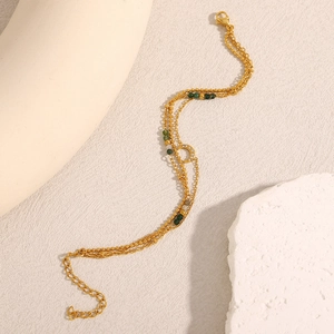Detail of multi-layer 18K gold plated bracelet with moon pendant and green beads