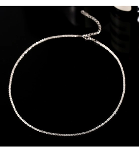 Macro shot of silver shimmering chain with adjustable lobster clasp on black mirror surface