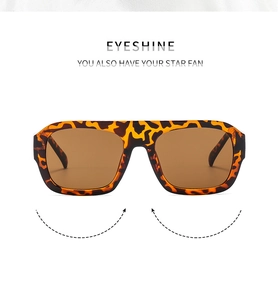Detail of tortoise shell frame sunglasses with brown gradient lenses on white background
