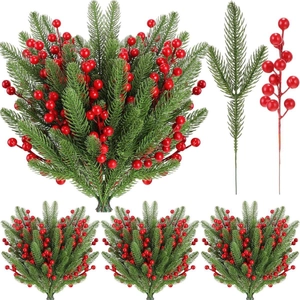 Detailed view of artificial pine needles and red holly berries for festive home decoration