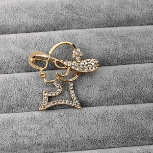 Detailed view of elegant lady profile brooch in gold alloy with white rhinestones